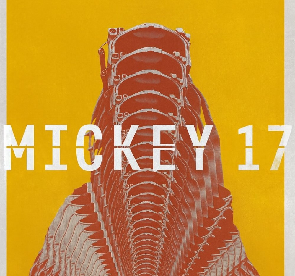 alt="Poster for 'Mickey 17' featuring a repeated distorted figure in a spacesuit against a bright yellow background with the title in bold white text."
