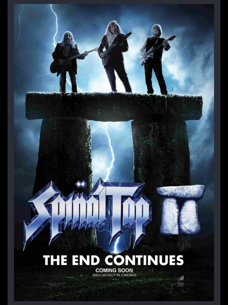 alt="Poster for 'Spinal Tap II' showing three band members standing on a Stonehenge-like rock formation with electric guitars as lightning strikes behind them, set against dark storm clouds with the tagline about the end continuing."