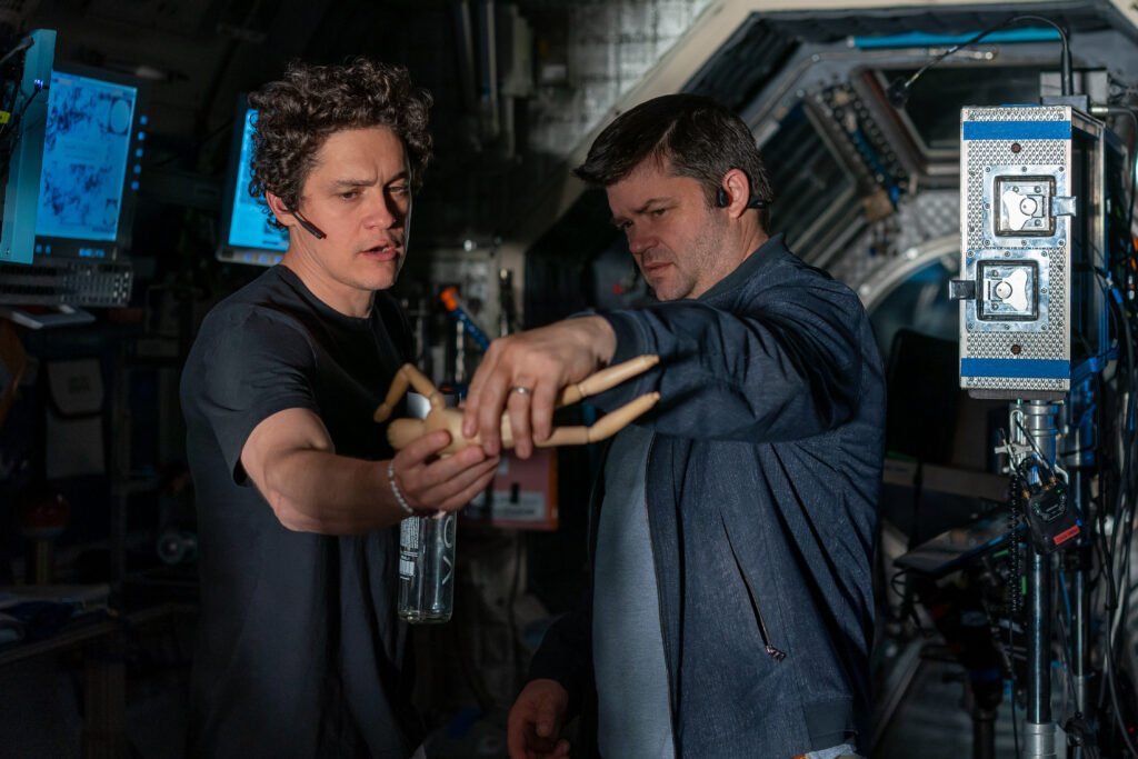 Alt attribute:  
Phil Lord and Christopher Miller stand inside a spacecraft‑style set surrounded by monitors and equipment during the making of Project Hail Mary, shown here to accompany a Project Hail Mary movie review.