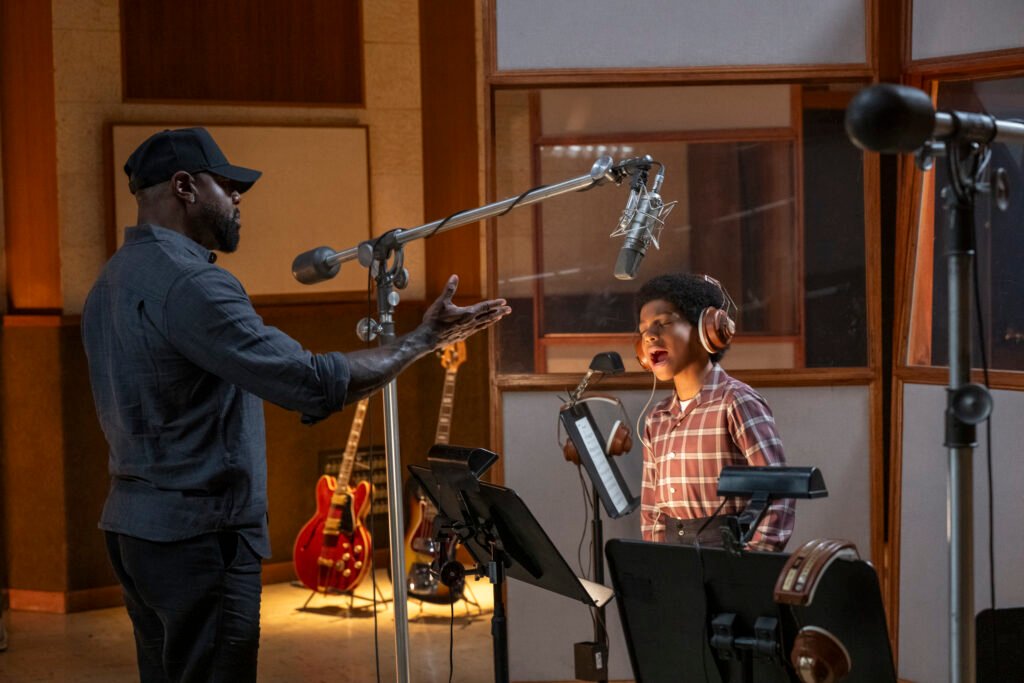 Director Antoine Fuqua and Juliano Krue Valdi as Young MJ in Michael. Photo Credit: Glen Wilson/Lionsgate Michael Biopic Movie Review