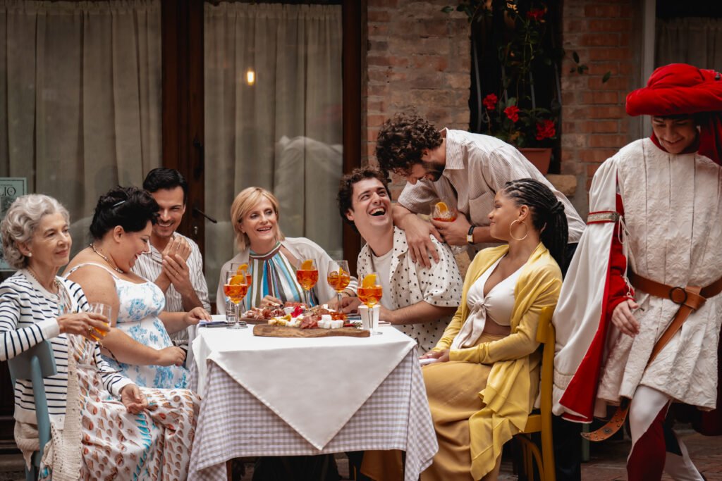 Alt = from left) Nonna Alessia (Stefania Casini), Francesca (Stella Pecollo), Leo (Luca Setaccioli), Gabriella (Isabella Ferrari), Enzo (Tommaso Cassissa), Matteo (Lorenzo de Moor) and Anna (Halle Bailey) in You, Me & Tuscany, directed by Kat Coiro. © Universal Pictures 2026

You Me Tuscany Film Review