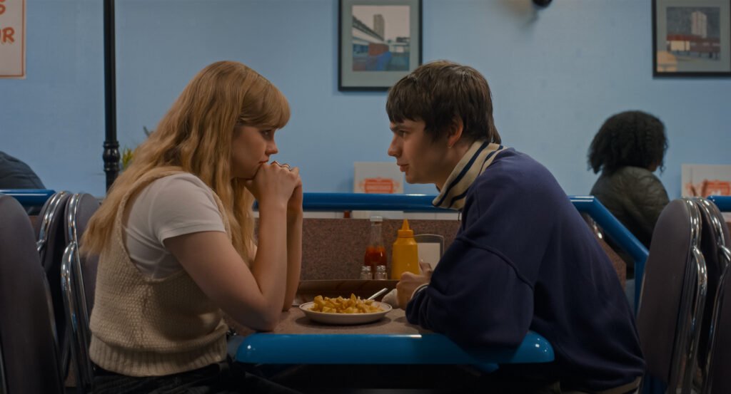 Alt = Angourie Rice stars as Emily and Spike Fearn as Owen in director Alicia MacDonald’s FINDING EMILY, a Focus Features release. Credit: Courtesy of Focus Features / © 2026 FOCUS FEATURES LLC And Universal Pictures 
Finding Emily romantic comedy review
