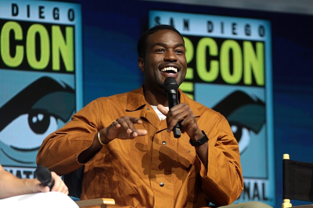 Alt = Yahya Abdul-Mateen II speaking at the 2018 San Diego Comic Con International, for "Aquaman", at the San Diego Convention Center in San Diego, California.
