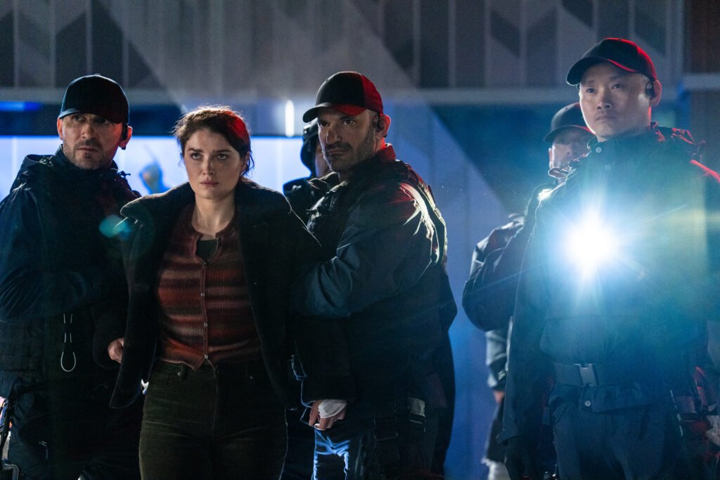 Alt = Eve Hewson (second from left) in DISCLOSURE DAY, directed by Steven Spielberg.

