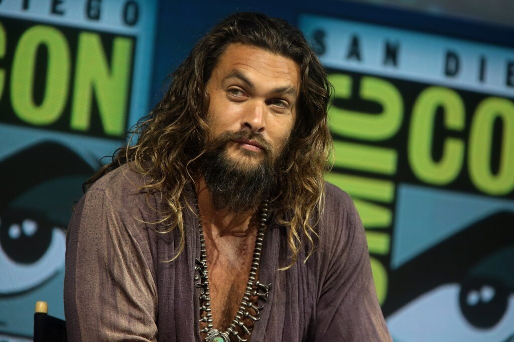Alt = Actor Jason Momoa speaking at the 2018 San Diego Comic Con International. By Gage Skidmore ©Creative Commons Attribution-Share Alike 2.0
Supergirl (2026) Review