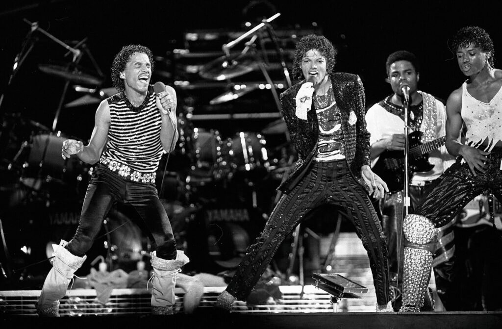 Alt = The Jacksons performing on stage at Arrowhead Stadium, Kansas City, during the Victory Tour By Larry Davis, Los Angeles Times ©Creative Commons Attribution 4.0
Michael Movie Billion-Dollar Success