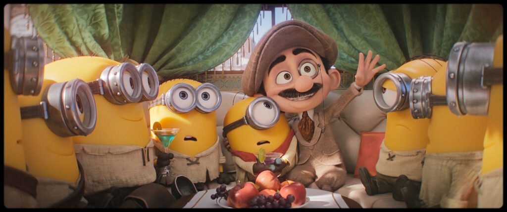 Alt = The Minions with Max (Voiced By Christoph Waltz) in Illumination’s Minions & Monsters, directed by Pierre Coffin.
Minions & Monsters Review