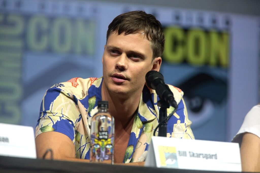 Alt = Bill Skarsgård speaking at the 2018 San Diego Comic Con International By Gage Skidmore ©Creative Commons Attribution-Share Alike 2.0
The Death Of Robin Hood Review