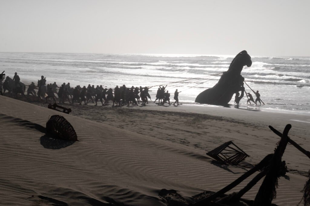 Alt = A Scene From THE ODYSSEY Featuring The Trojan Horse, The Odyssey written, produced, and directed by Christopher Nolan. Image © Universal Pictures 2026
The Odyssey Review