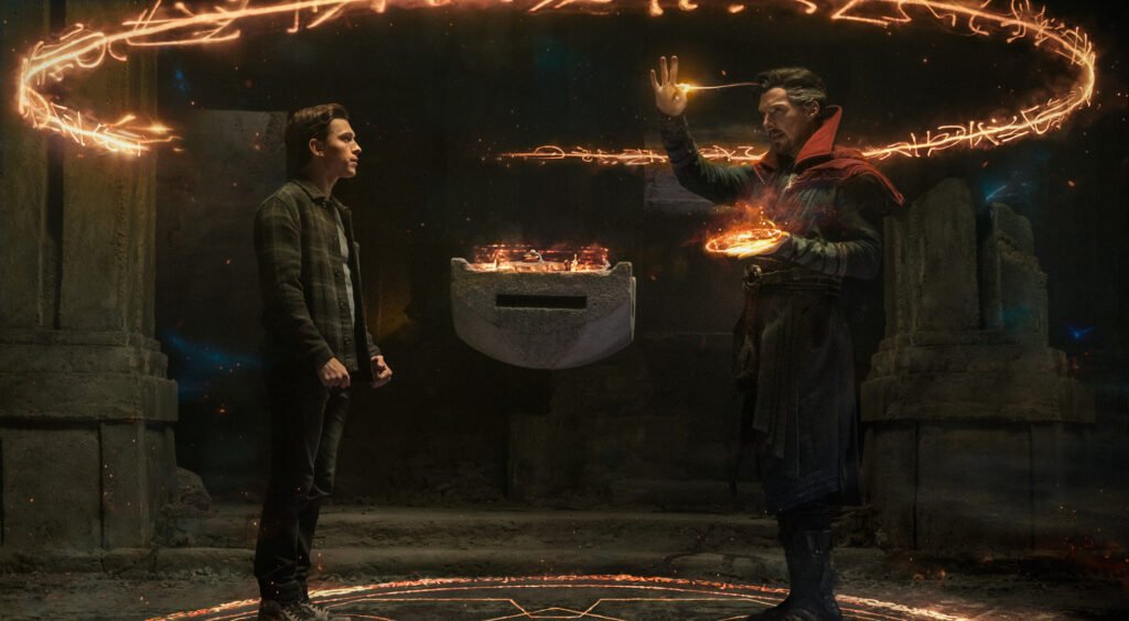 Alt = Tom Holland stars as Peter Parker/Spider-Man and Benedict Cumberbatch stars as Doctor Strange in Columbia Pictures’ SPIDER-MAN: NO WAY HOME.
Spider-Man: No Way Home Review