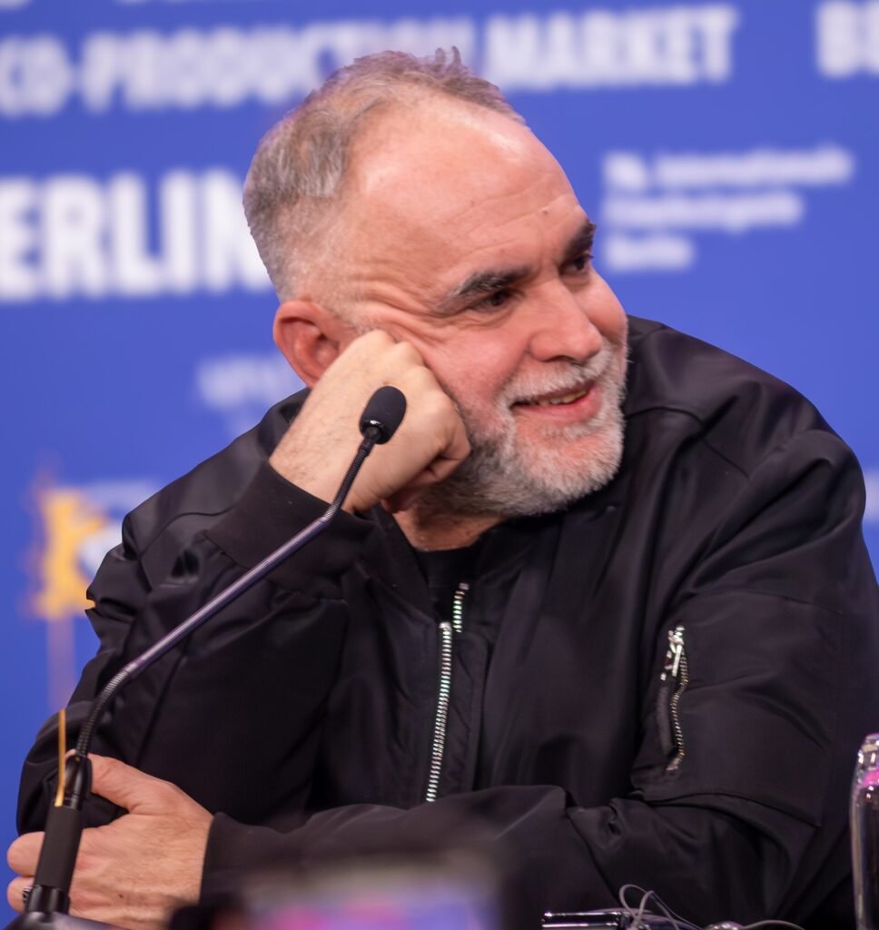 Alt = Karim Aïnouz at the Berlin Film Festival 2026 
By User:Celestinesucess ©Creative Commons Attribution-Share Alike
Rosebush Pruning Movie Review