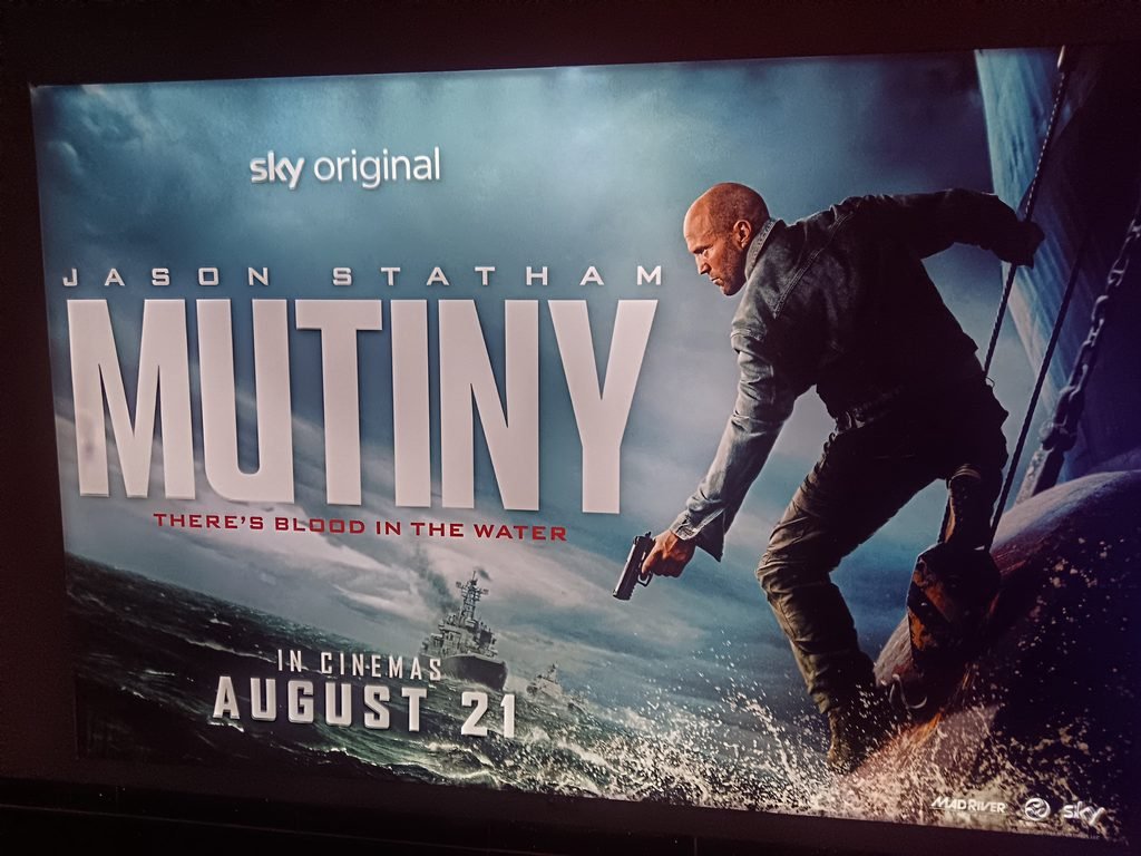 Alt = movie poster in cinema display for the 2026 movie mutiny
Mutiny 2026 Movie Review