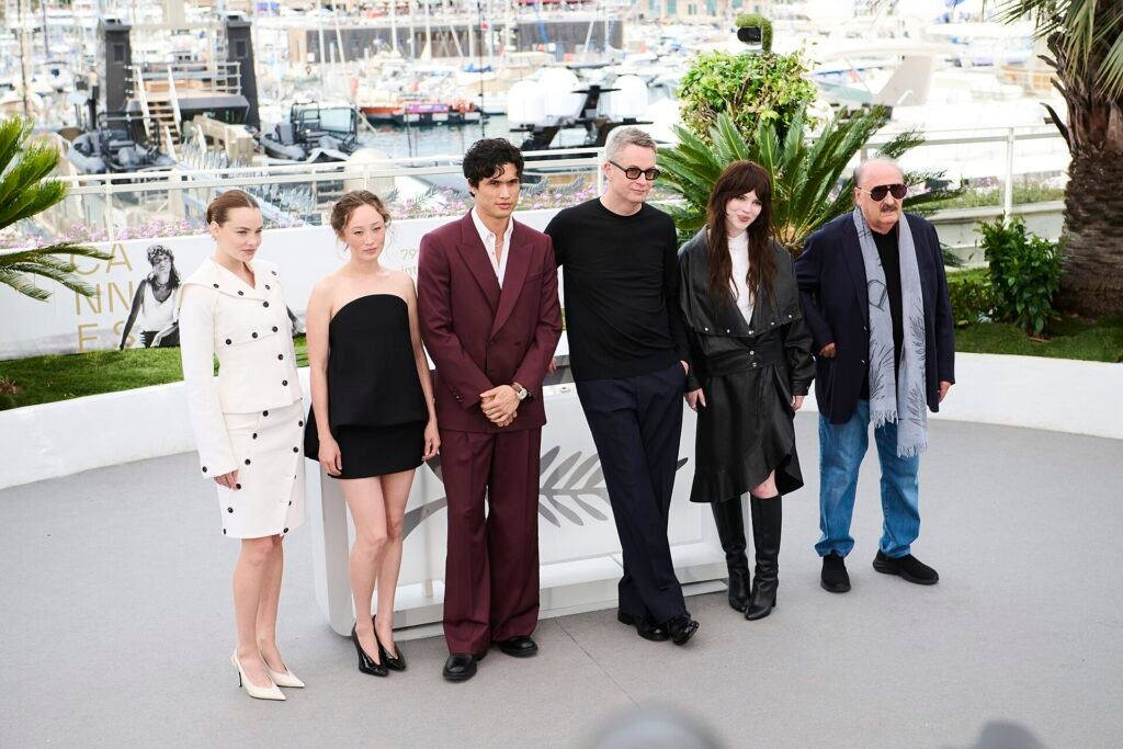 Alt = Kristine Froseth, Havana Rose Liu, Charles Melton, Nicolas Winding Refn, Sophie Thatcher and Pino Donaggio pose during the Her Private Hell photocall at the 79th annual Cannes Film Festival By Gabriel Hutchinson ©Creative Commons Attribution-Share Alike 4.0