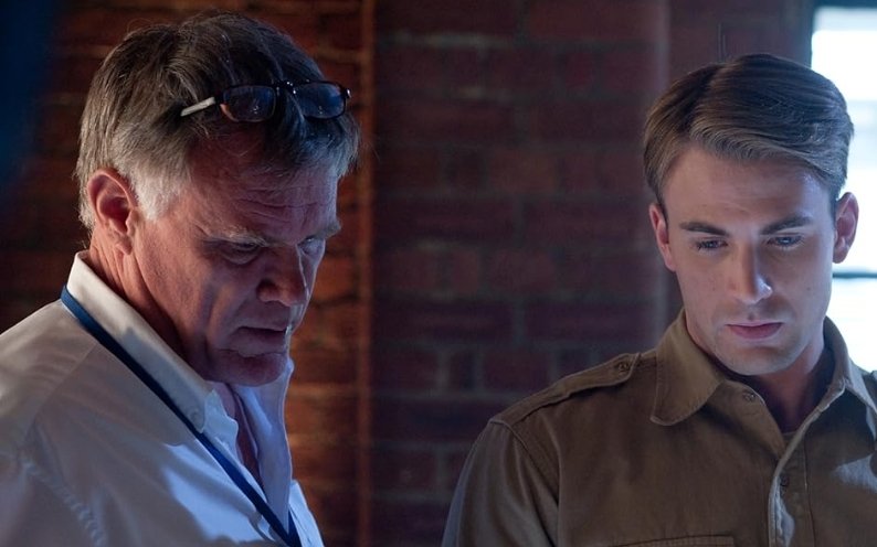 Alt = Joe Johnston and Chris Evans in Captain America: The First Avenger (2011) TM and Copyright © Marvel Studios and the Walt Disney Company. All rights reserved.
Captain America: The First Avenger: Review