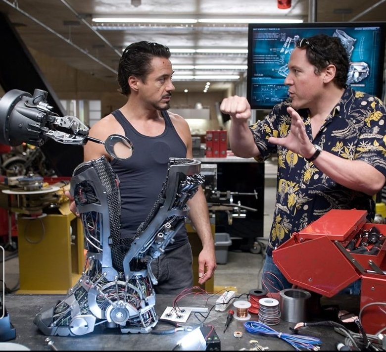Alt = Robert Downey Jr. And Jon Favreau on the set of Iron Man (2008) ©Marvel Studios and the Walt Disney Company. All rights reserved.
Iron Man Review