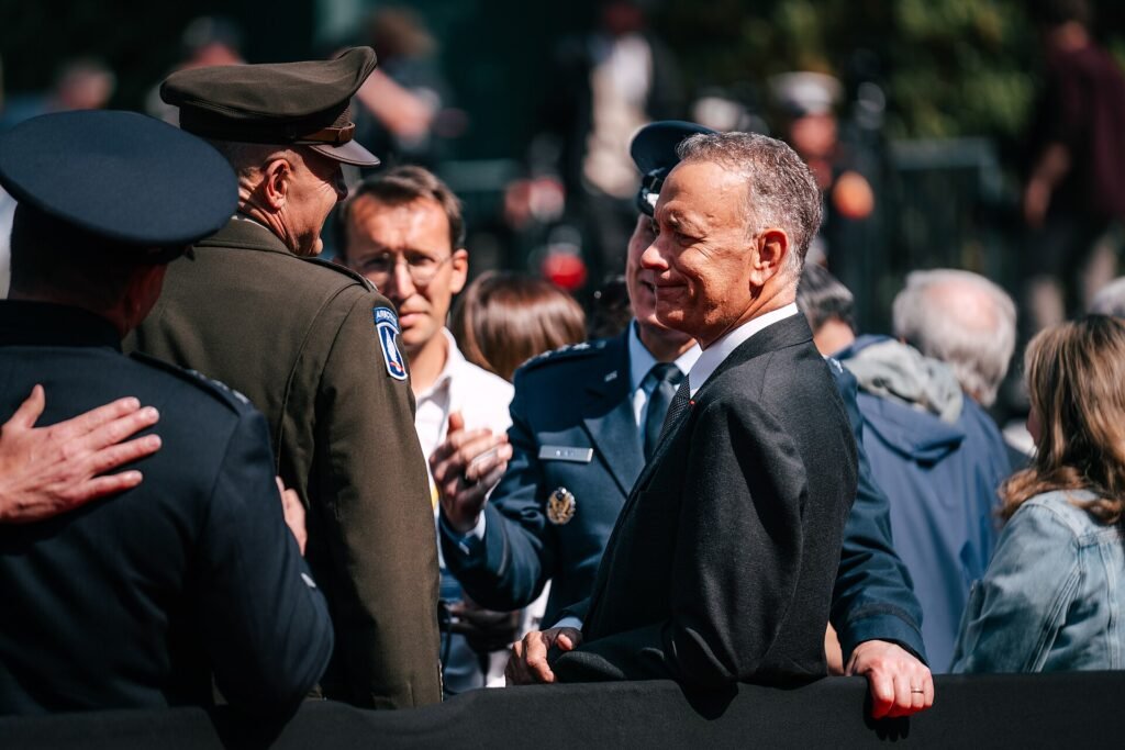 Alt = U.S. Civilian Tom Hanks attends the official D-Day 80th Anniversary Commemoration at the Normandy American Cemetery. The Cemetery is home to over 9,000 American soldiers from World War Two. (U.S. Army photo by Sgt. Landon Carter)
World War II with Tom Hanks: Review