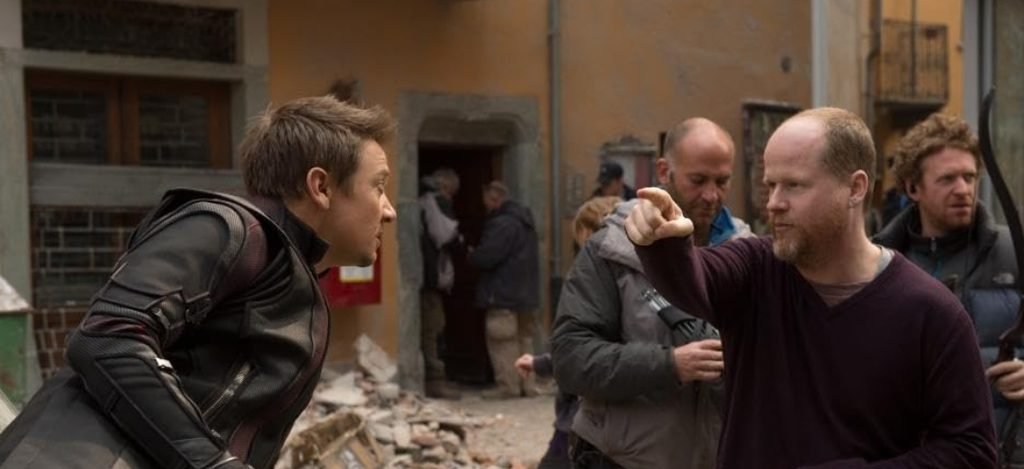 Alt = Jeremy Renner And Director Joss Whedon On the set of The Avengers Age Of Ultron (2015). ©Marvel Studios and the Walt Disney Company. All rights reserved