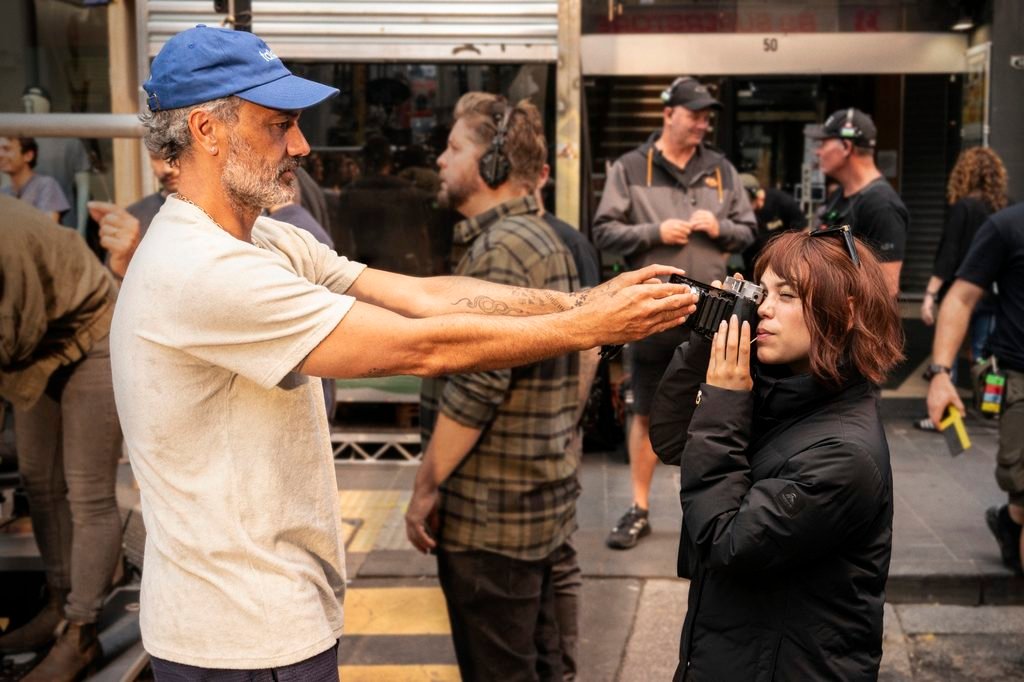 Alt = Director Taika Waititi and Jenna Ortega on the set of Klara and the Sun (2025). Courtesy of Sony Pictures